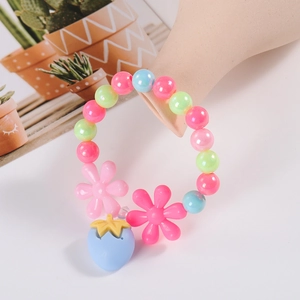 Detailed macro view of children's colorful beaded bracelet with cute pink flower charms