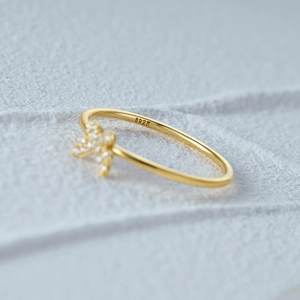 Macro shot of S925 sterling silver gold plated ring with zircon bow knot detail