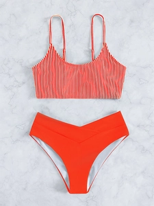 Detail of red striped bikini top with adjustable straps and V-cross high waist bottom