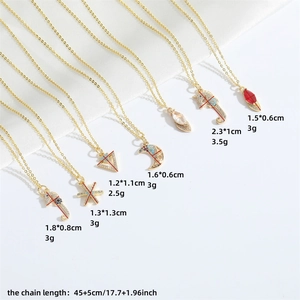 Gold necklaces with seahorse moon and triangle pendants on elegant white silk background