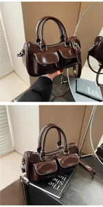 Detail view of deep brown vintage saddle bag with front pockets and dual handles