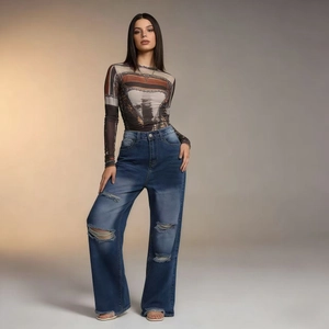 Detail of high-waisted blue distressed jeans with ripped knees and vintage wash style