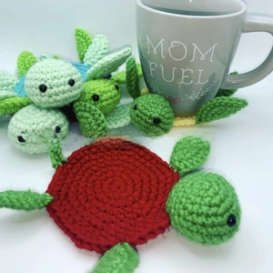 Detailed knit texture of handmade colorful turtle crochet coasters with mug