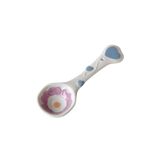 Handcrafted white ceramic spoon with floral motifs and blue hearts for desserts