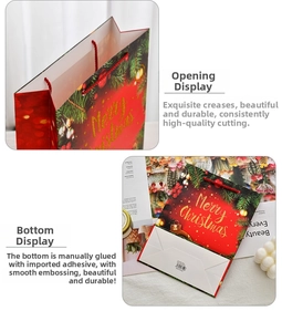 Detail of red Christmas gift bag with gold Merry Christmas print and rope handles