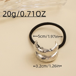 Detailed view of black elastic hair tie with silver hammered metal cross decorative piece
