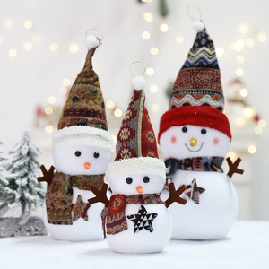 Three plush Christmas snowmen dolls in varying sizes with festive knit hats and scarves
