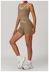 Detail of cross-back yoga set in olive brown with white contrast piping and high waist