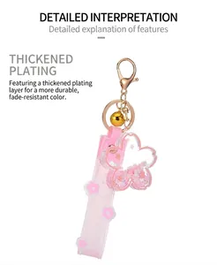 Macro view of a pink Sakura liquid quicksand keychain with thickened gold plating