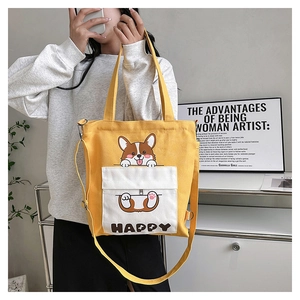 Detail of yellow canvas tote with cartoon corgi print and dual carry handles