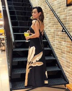 Detail of the backless tie-up straps and palm leaf print on the long summer dress