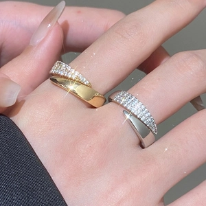 Close-up of gold and silver open rings with multi-row pavé-set sparkling zircons