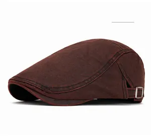 Detail showing the burgundy cotton newsboy cap with vintage metal side buckle