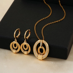 Elegant gold jewelry set with pavé zircon pendant necklace and matching hoop earrings