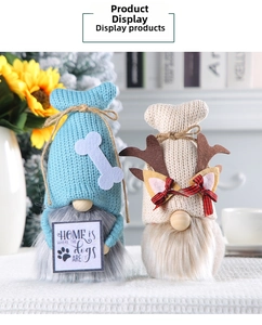 Detail of Nordic knitted gnomes featuring blue fish-tail hat and beige reindeer antlers