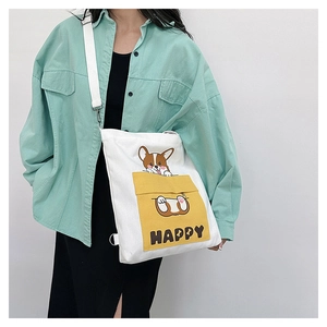 Detail of white canvas crossbody bag with yellow Corgi pocket and Happy text print
