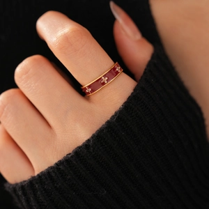 Macro shot of 18k gold plated vintage flower ring with red enamel and zircon accents
