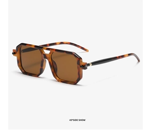 Detail view showing tortoise shell pattern frames and brown lenses of retro sunglasses