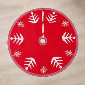 Red wool knit Christmas tree skirt with white snowflake patterns on wooden floor 120cm
