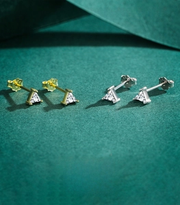 Macro shot of triangle-cut cubic zirconia stud earrings with S925 sterling silver hallmarks