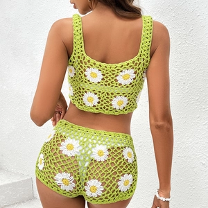 Two-piece green crochet bikini set with daisy appliques and high-waisted shorts