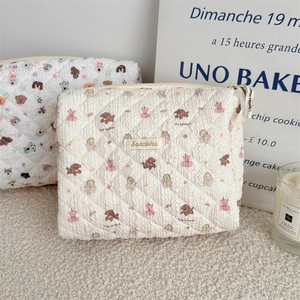 Detailed view of quilted cotton makeup bags with cute cartoon puppy and bear prints