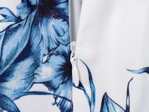 Close-up of invisible zipper and floral print texture on the blue and white dress