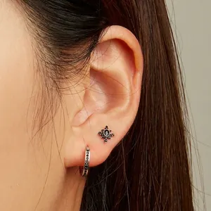 925 silver earring set featuring black zircon hoop and retro star stud on female model