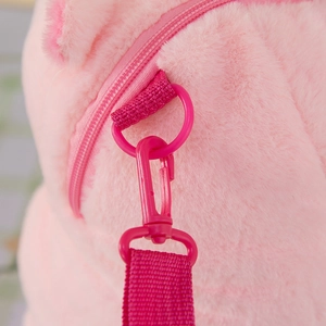 Close-up of pink plush capybara backpack showing plastic hook and zipper texture