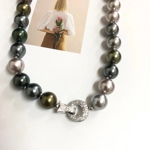 Detail of Tahitian style multi-color pearl necklace with crystal-inlaid silver clasp