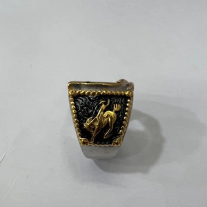 Close-up of western style stainless steel ring featuring a gold bronco rider on silver band