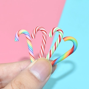 Detailed macro view of four colorful miniature polymer clay candy canes for DIY crafts