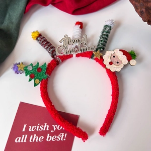 Detail of red plush Christmas headband with Santa, tree, and Merry Christmas text