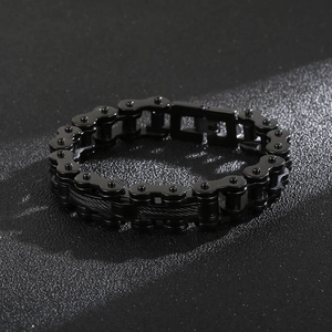 Detail of black stainless steel bike chain bracelet with industrial mechanical aesthetic