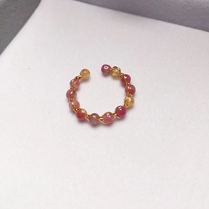 Macro detail of handmade 14K gold-filled wire wrapped ring with faceted tourmaline beads