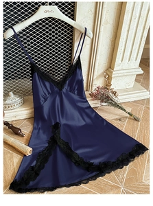 Macro shot of dark blue satin nightgown detail featuring delicate black lace trim and edges