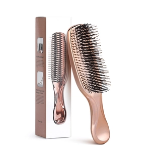 Macro view of rose gold scalp massage brush with professional packaging and features