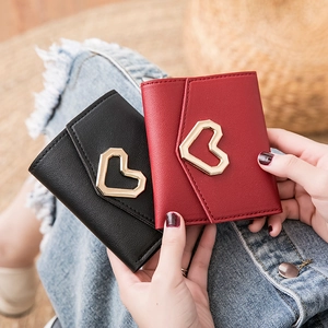 Short PU leather wallet with heart buckle held by model in black and red colors