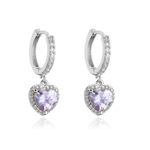 Macro shot of silver heart earrings with purple gemstone and micro-pavé crystal borders
