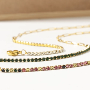 Detailed close-up of gold-plated tennis bracelets featuring vibrant multi-color zircon stones