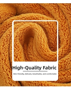 Close-up of soft brown coral fleece fabric with a fluffy texture and spiral folding