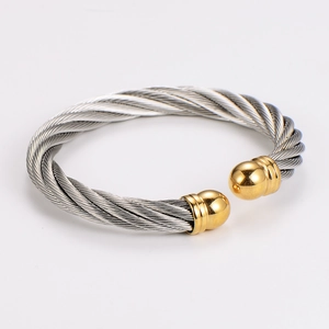 Detail of twisted cable bangle with silver wire and gold polished spherical ends