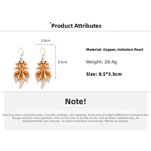 Detail view of koi fish earrings with enamel finish and imitation pearls for women