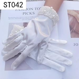 Close-up of white satin bridal gloves with dense pearl embellishments at the wrist