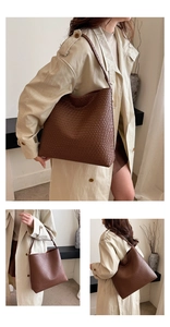 Detail shot of brown woven leather tote bag texture and over-the-shoulder styling