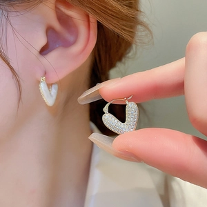 Asymmetric gold-plated heart drop earrings with white enamel and sparkling cubic zirconia