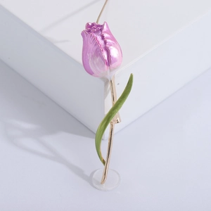 Elegant purple tulip brooch with gold stem and green leaves on white background