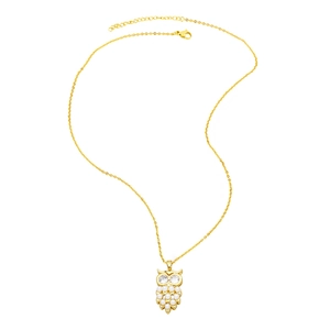 Macro detail of golden owl pendant necklace with white pearls and sparkling crystal eyes