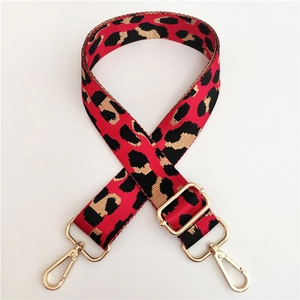Detail of red leopard nylon strap with gold lobster hooks and adjustable metal slider