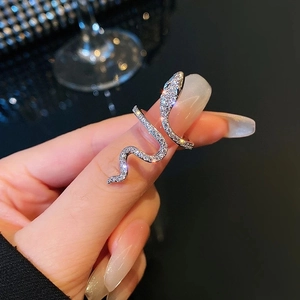 Silver snake wrap ring with micro-pave cubic zirconia on model's hand with bokeh background